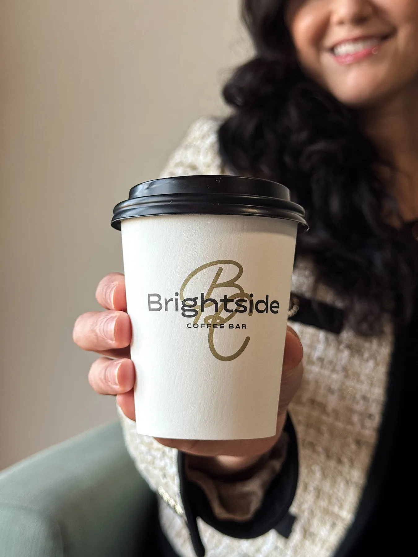 Guest holding a custom-branded Brightside coffee cup at a Houston event