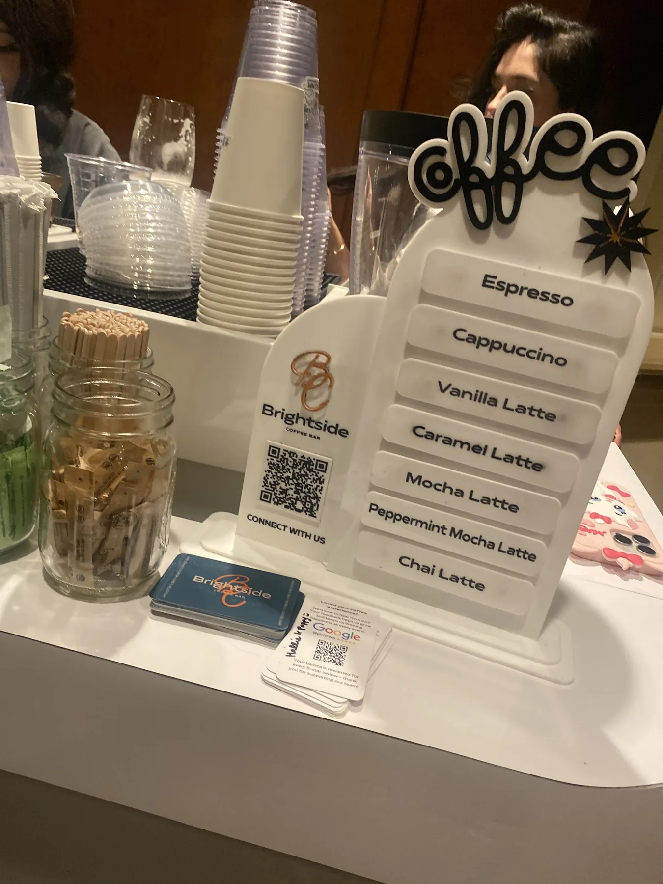 Brightside coffee catering menu board and cups at a Houston espresso bar