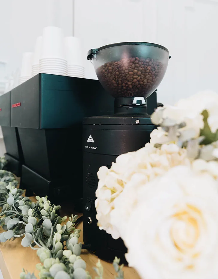 Espresso grinder and white florals styled on a Brightside coffee bar in Houston
