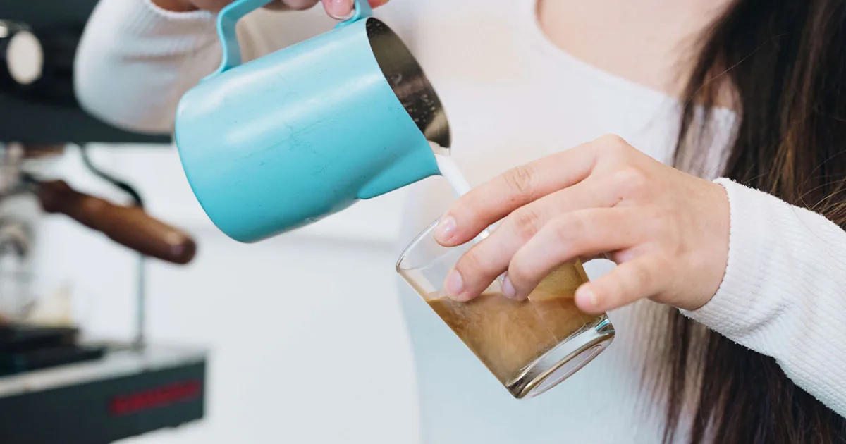 Iced Brightside latte being poured at a Houston espresso bar catering setup