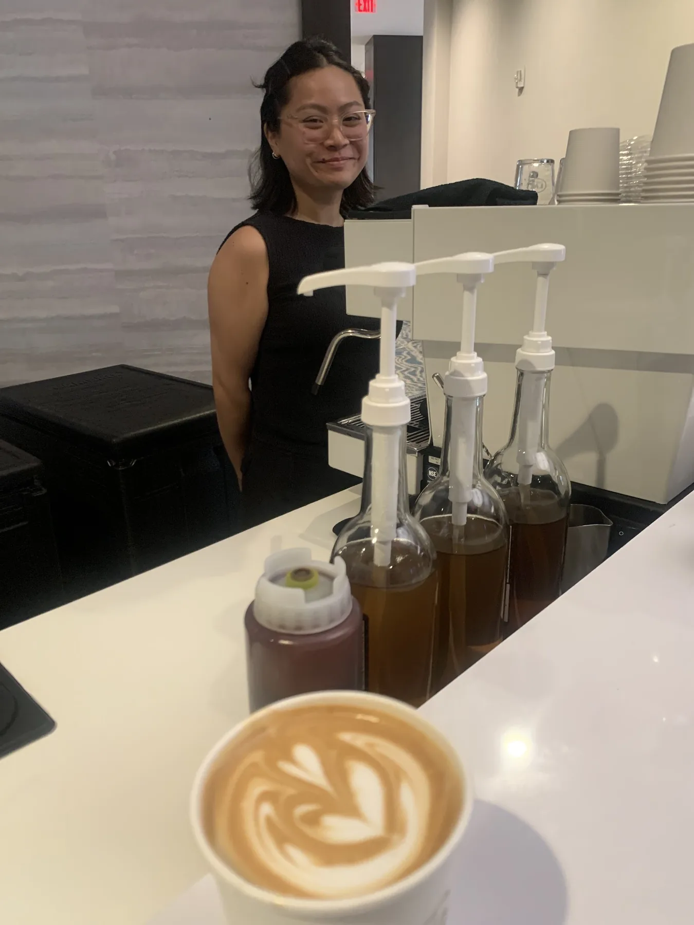 Barista finishing latte art at a Houston coffee catering bar