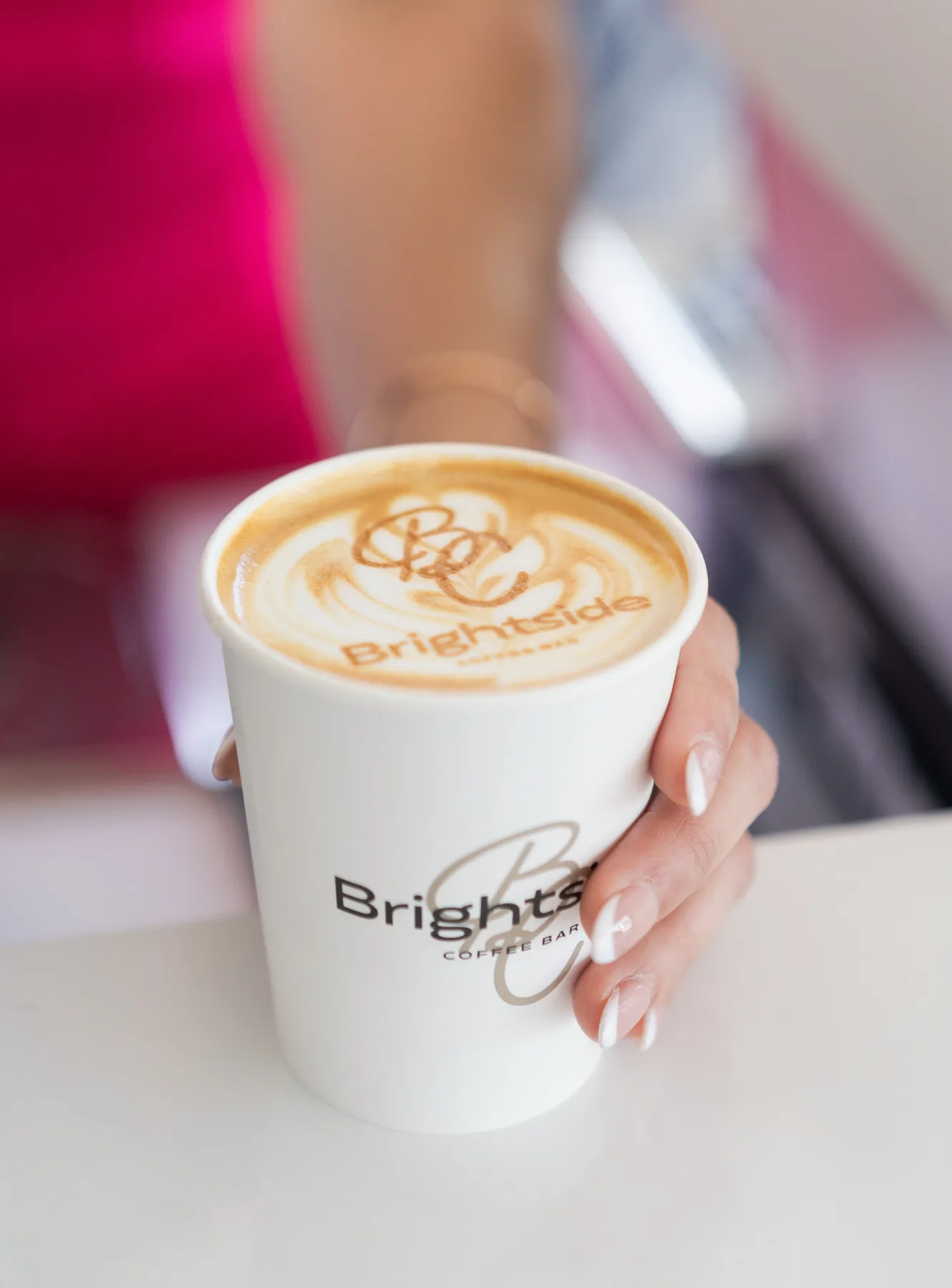 Close-up of a latte with the Brightside logo printed in the microfoam