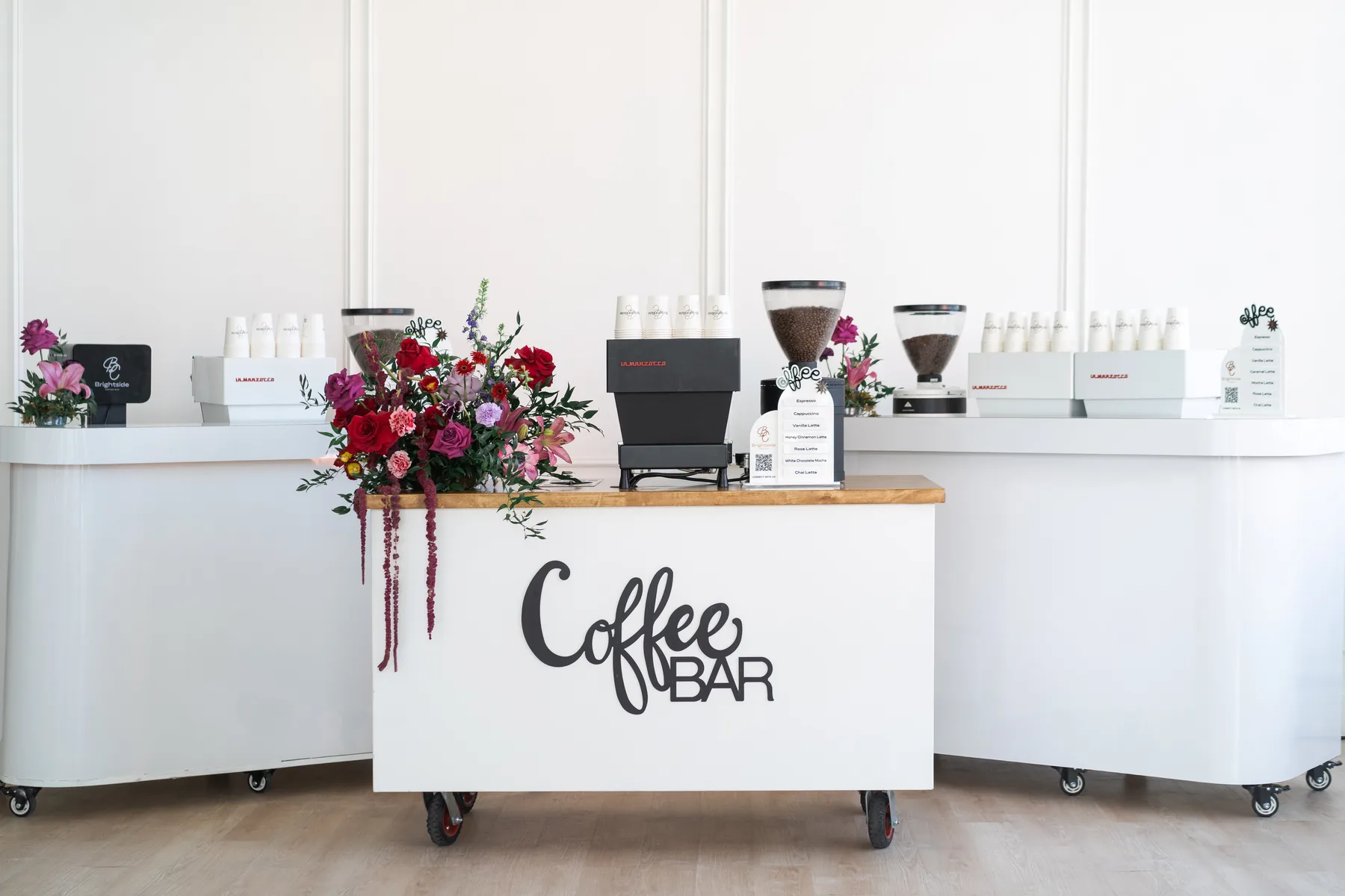Brightside white mobile coffee bar styled with florals at a Houston wedding reception